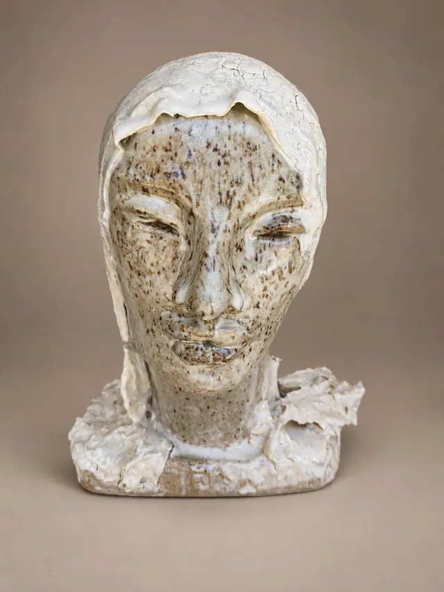 Head of a woman in a speckled glaze