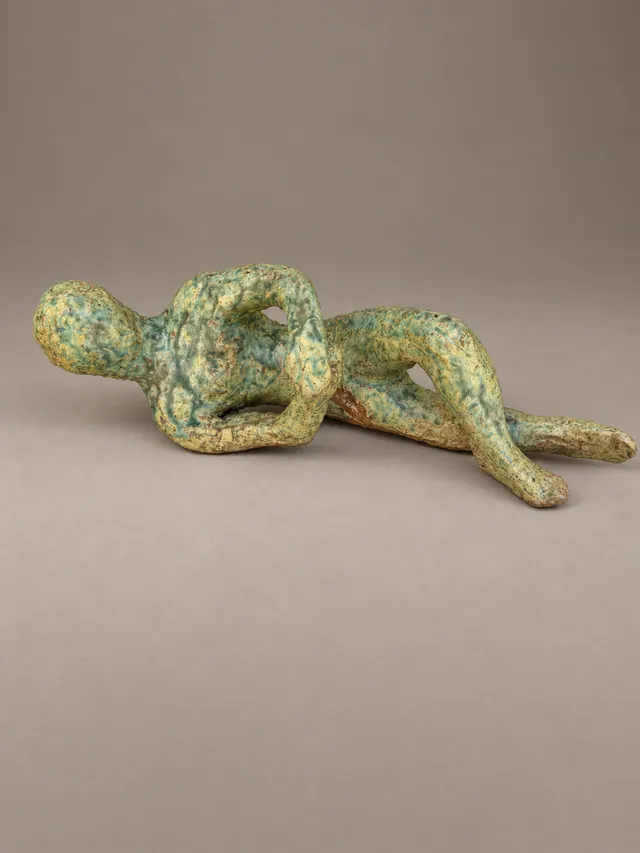 Reclining figure in mottled green glaze